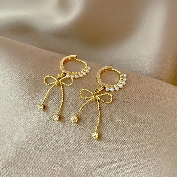 Clémentine Paris Boucles d'oreilles décorées avec des nœuds papillon - OG008
